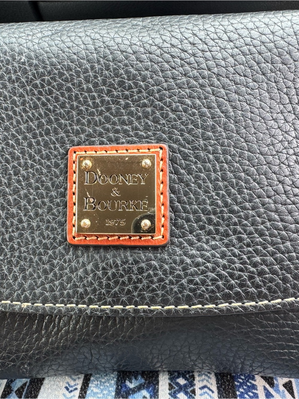 Dooney & Bourke Black Pebbled Leather Crossbody with Brown Trim and Gold Plaque